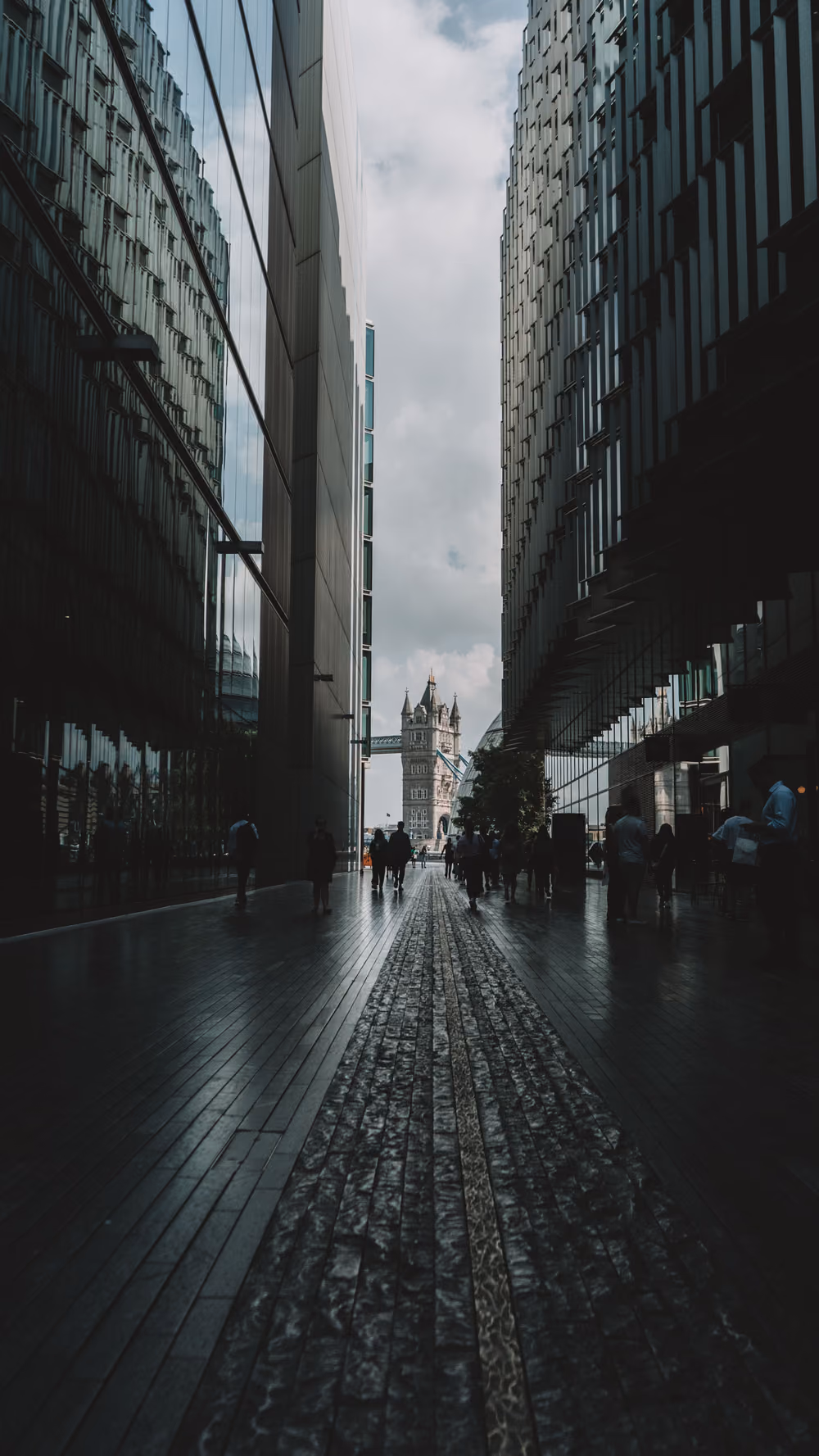 A narrow city alley closing in toward a distant landmark