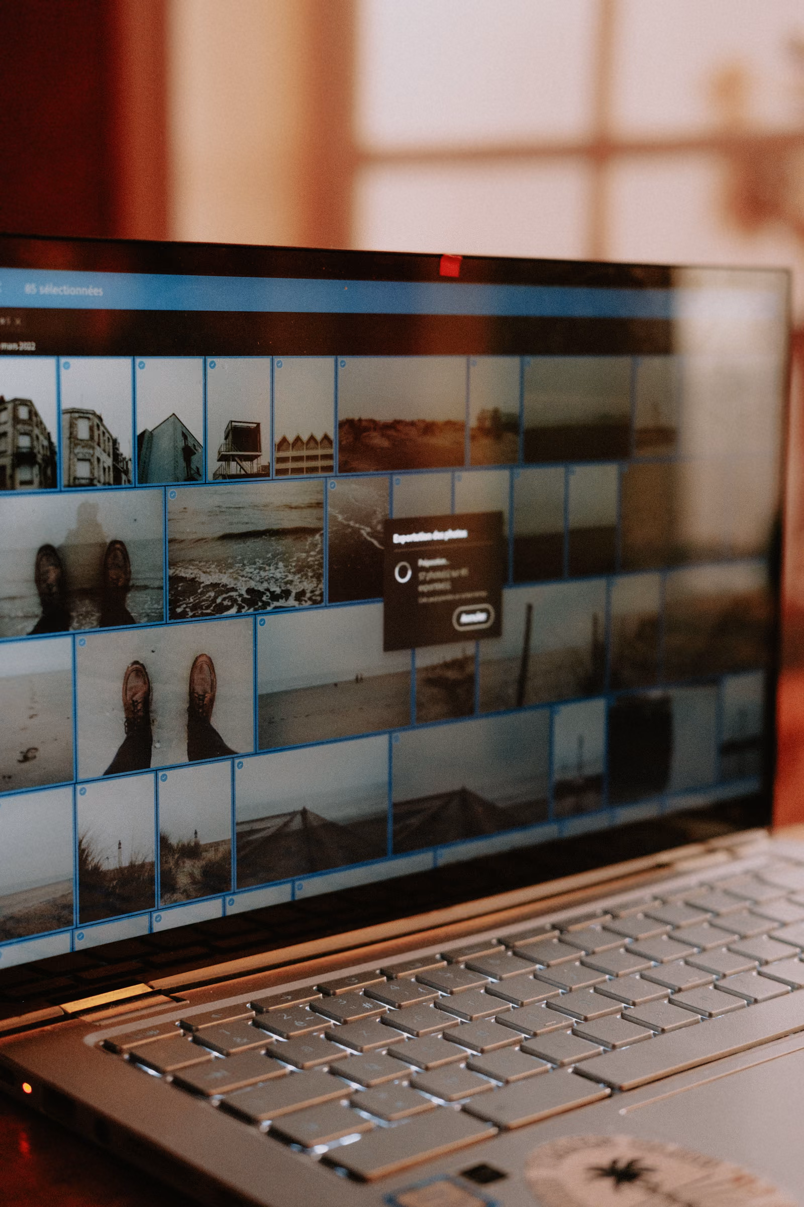A gallery wall of printed photographs arranged in a grid